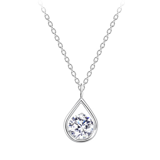 A sterling silver chain necklace with a tear drop shaped pendant hanging against a white backdrop. In the pendant is a round white cubic zirconia. 