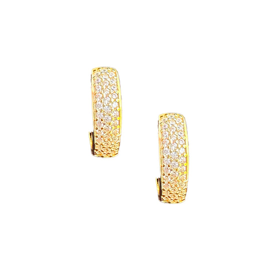 A pair of gold-plated sterling silver huggie hoop earrings set against a white backdrop. The earrings have 3 columns of white cubic zirconia set in a pave style.