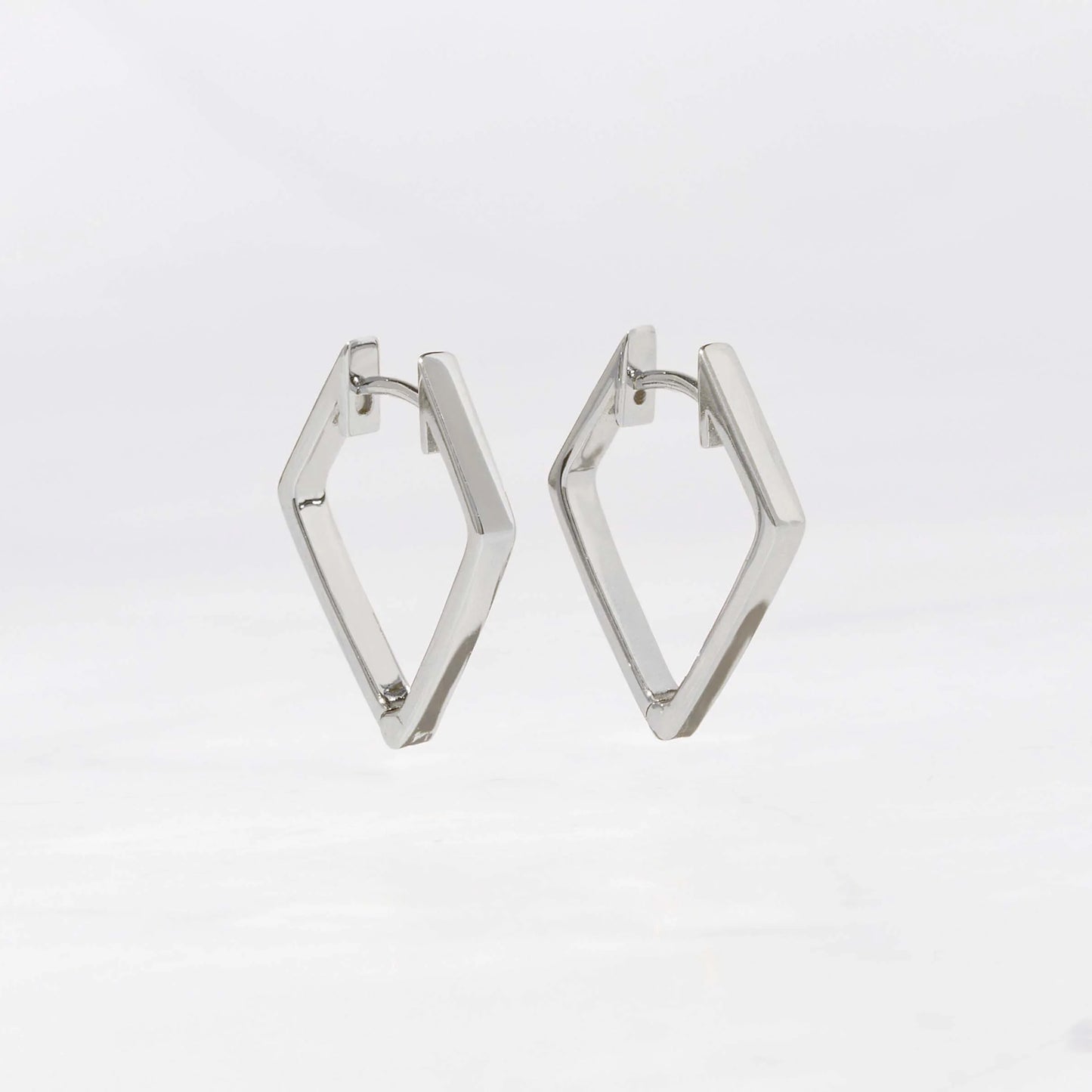 Sterling silver hoop earrings in the shape of a kite set against a white background. The earrings have 4 sides, excluding the post, and come to a point at the bottom.