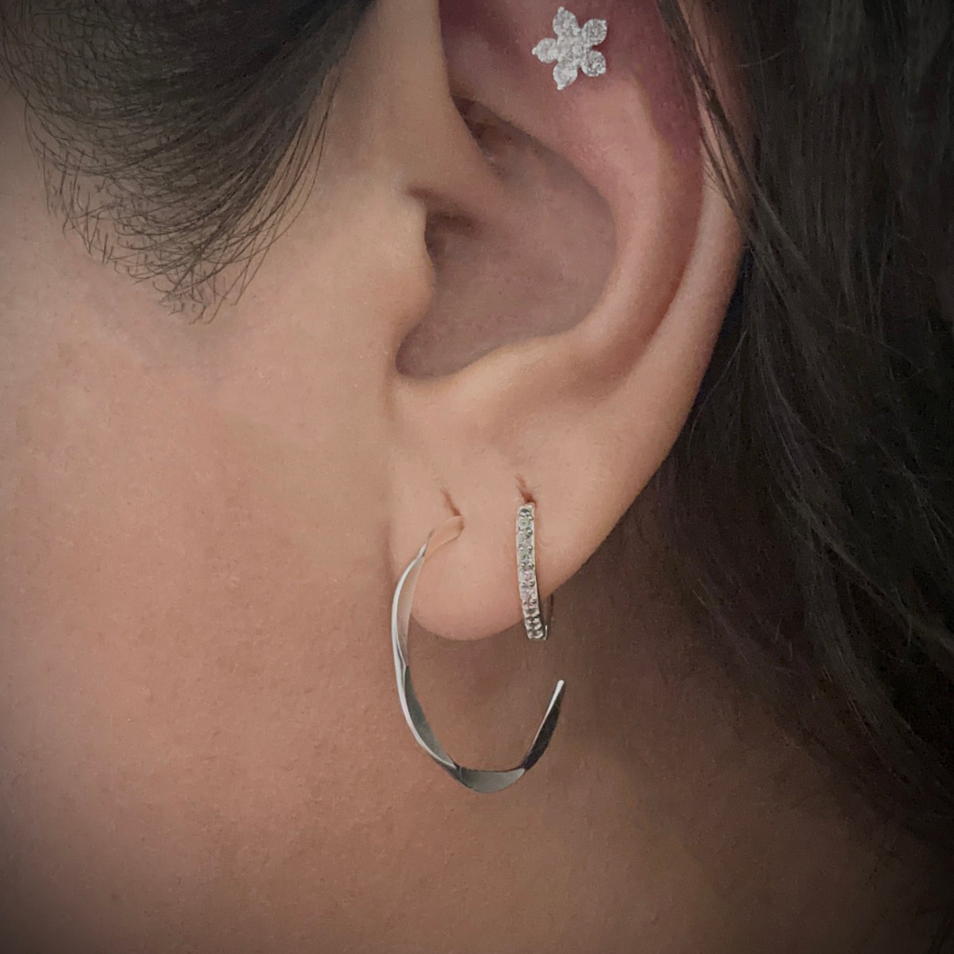 Silver Chic Pave Cubic Zirconia Huggie Earrings in second lobe piercing.