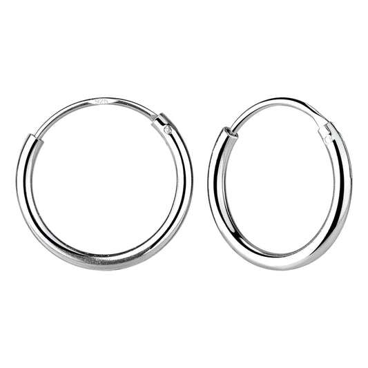 A pair of sterling silver endless hoops floating against a white backdrop.