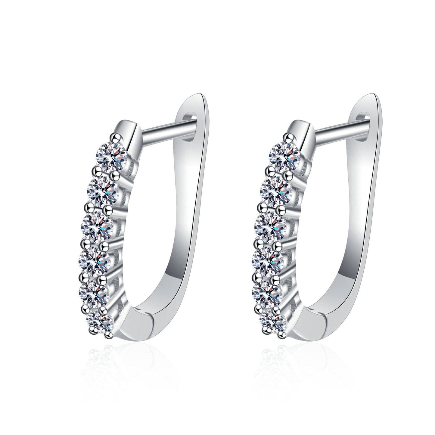 A pair of platinum-plated sterling silver oval hinged hoops floating against a white background. The front of the hoops are lined with 6 round-cut moissanite stones floating against a white background. The earrings are slightly facing to the left showing the hinge and clasp mechanism.
